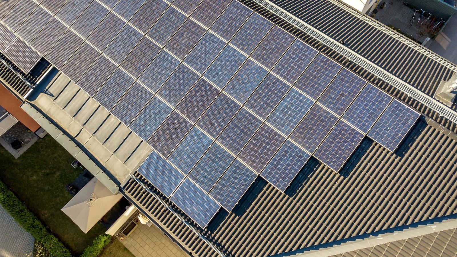 Solar technician fastening panels during solar panel repair in Howell Township NJ